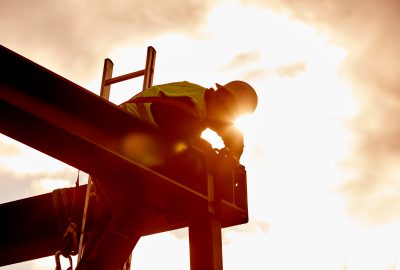 Steel construction with worker in backlight